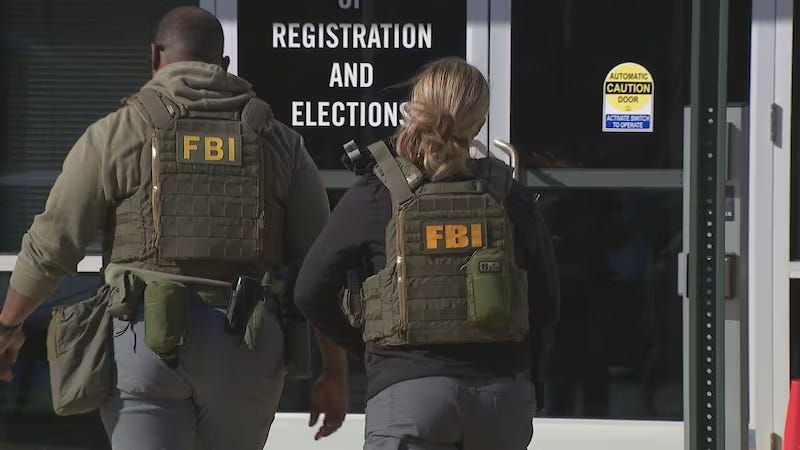 Two people in FBI vests and heavy equipment enter a door labeled "Office of Registration and Elections."