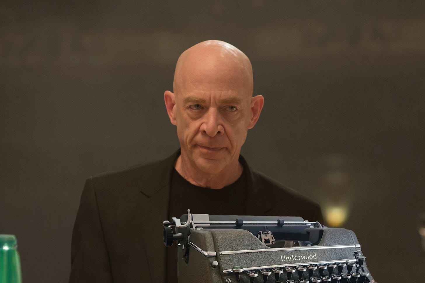 A stern bald man in black ready to throw a before a typewriter at a student's head, evoking the demanding mentor archetype from Whiplash.