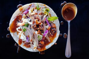 Peking-inspired Sonoran-style roast goose tacos with shredded cabbage, carrots, Salsa Macha and hoisin sauce. Food photography and recipe by Jackie Alpers.