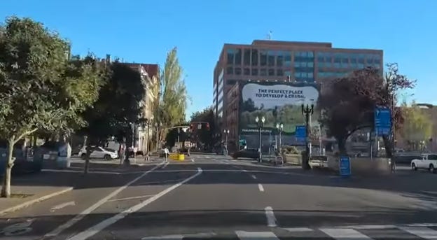 A street with buildings in the background

AI-generated content may be incorrect.