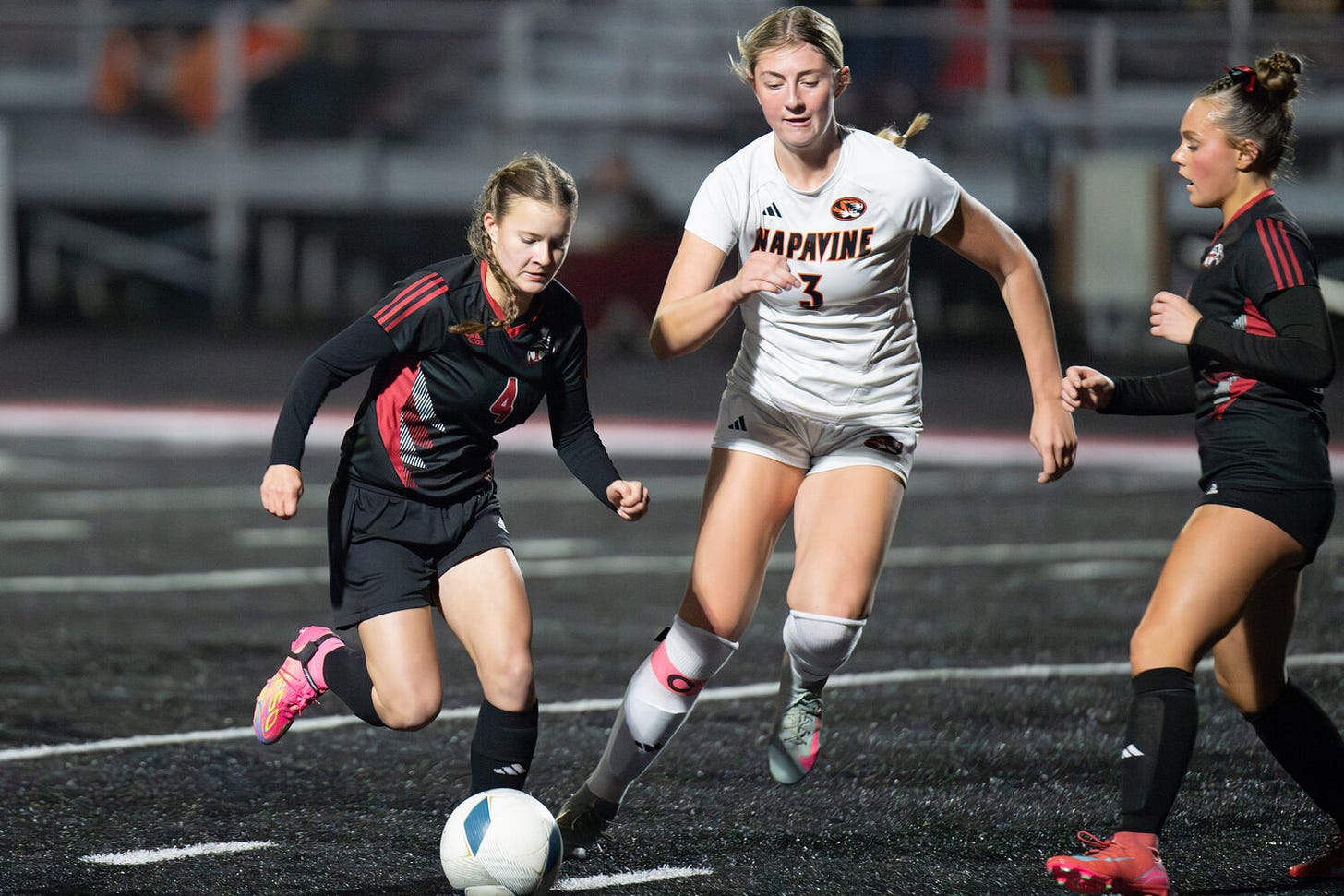 Napavine’s Hayden Kaut challenges two Toledo defenders during a game at Tenino High School on Saturday, Nov. 8.