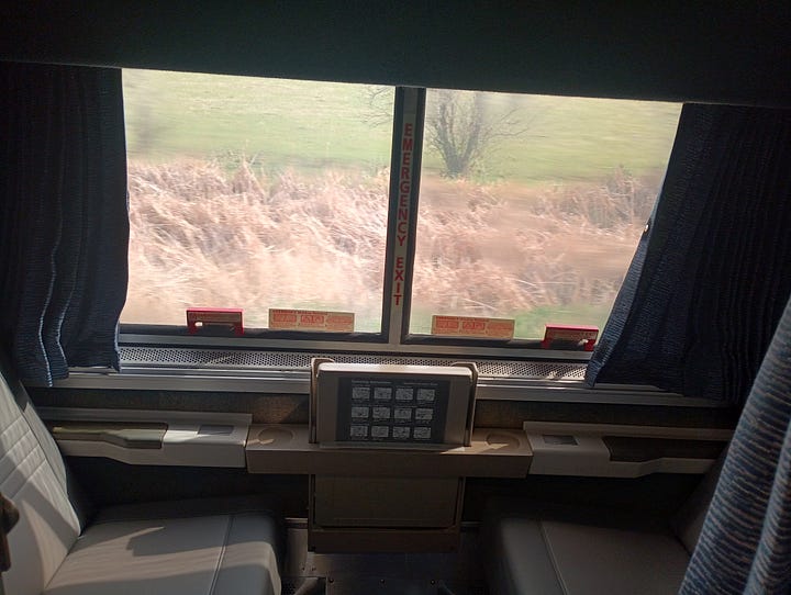 train room with a bath, and roomette, looking at the track behind the last car, looking down the very narrow hallway