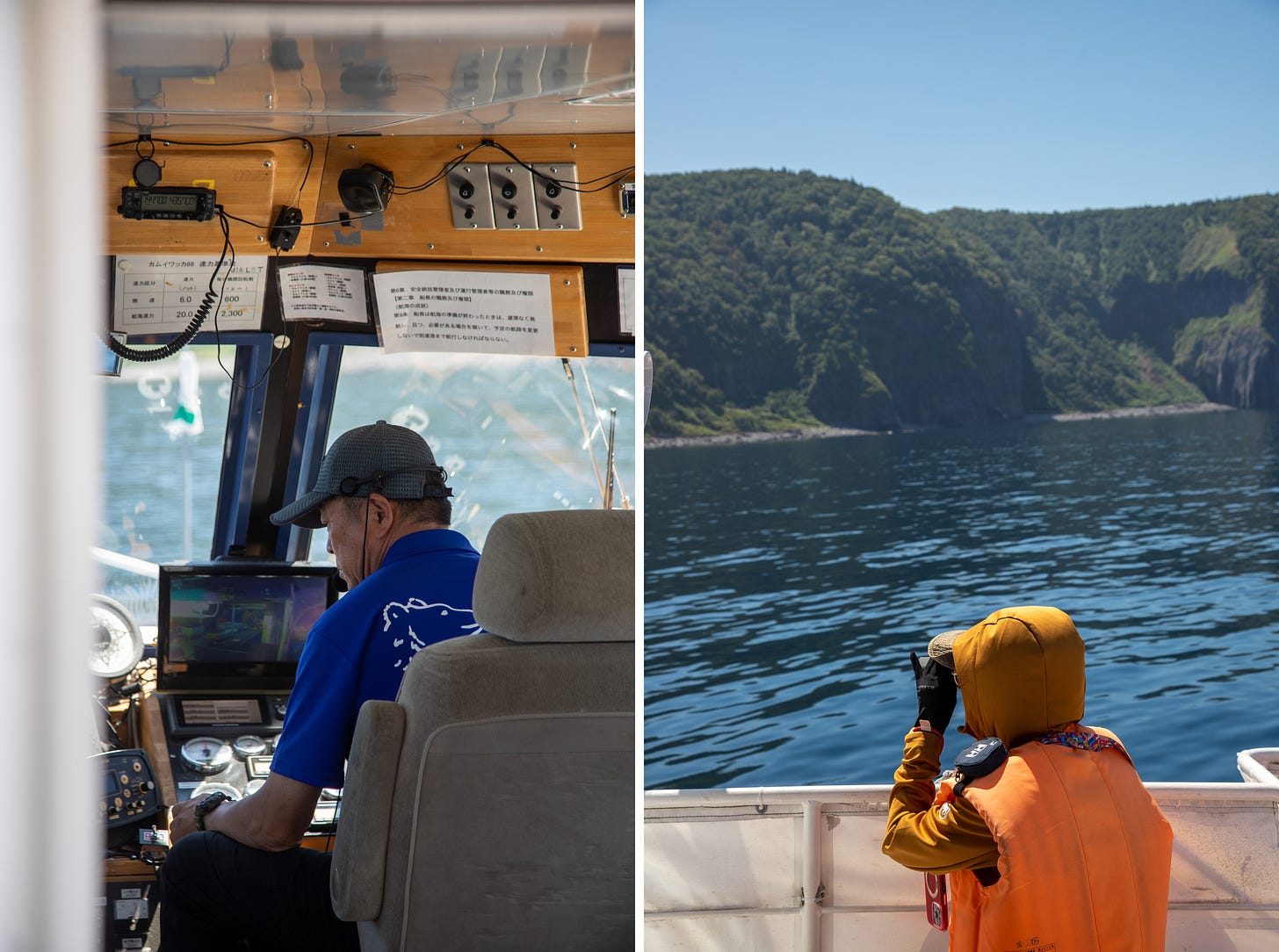 Left, a boat captain in a blue shirt and cap at the controls. Right, a passenger in a hood, gloves and orange life vest scanning the forested coastline through binoculars on a warm, sunny day.
