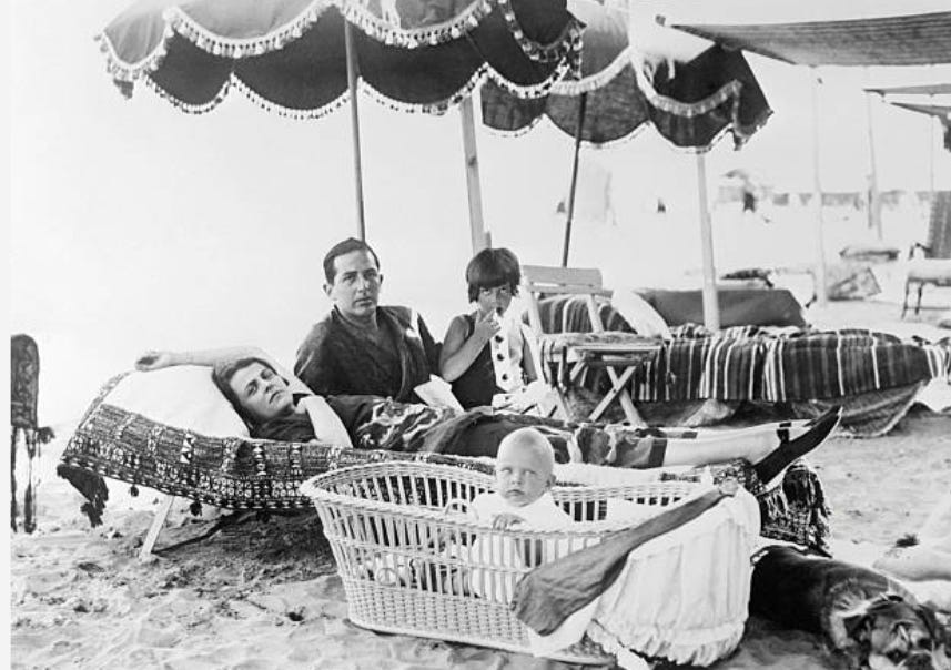 Dorothy Caruso with Gloria (right) at the Lido, Venice. Also pictured are her second husband, Captain Ernest Ingram, and their daughter, Jacqueline (in the crib).