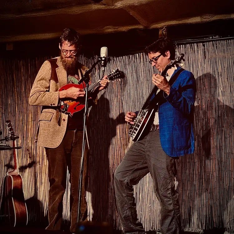 May be an image of 2 people, saxophone, guitar, accordion and clarinet