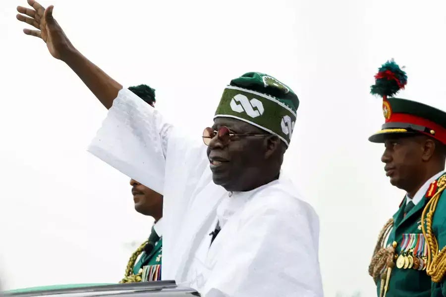 Nigeria's President Bola Tinubu waves to a crowd as he takes the traditional ride on top of a ceremonial vehicle, after his swearing-in ceremony in Abuja, Nigeria on May 29, 2023. Nigeria's President Bola Tinubu waves to a crowd as he takes the traditional ride on top of a ceremonial vehicle, after his swearing-in ceremony in Abuja, Nigeria on May 29, 2023.