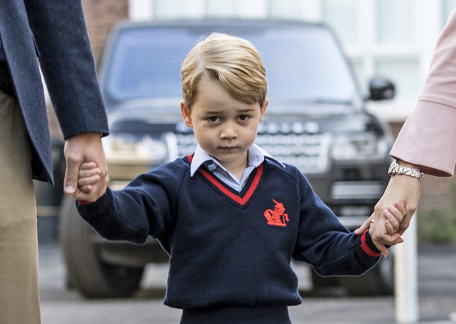 Prince George in school uniform holding hands with his parents Prince George in school uniform holding hands with his parents