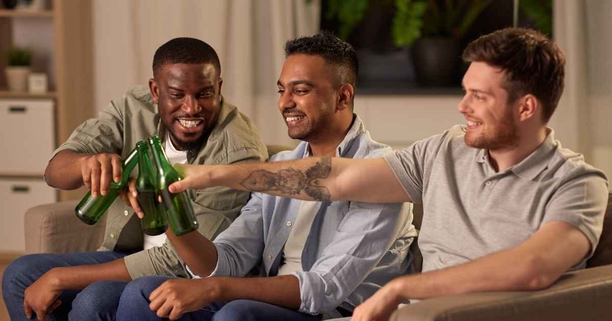 Three guys drinking beer at home