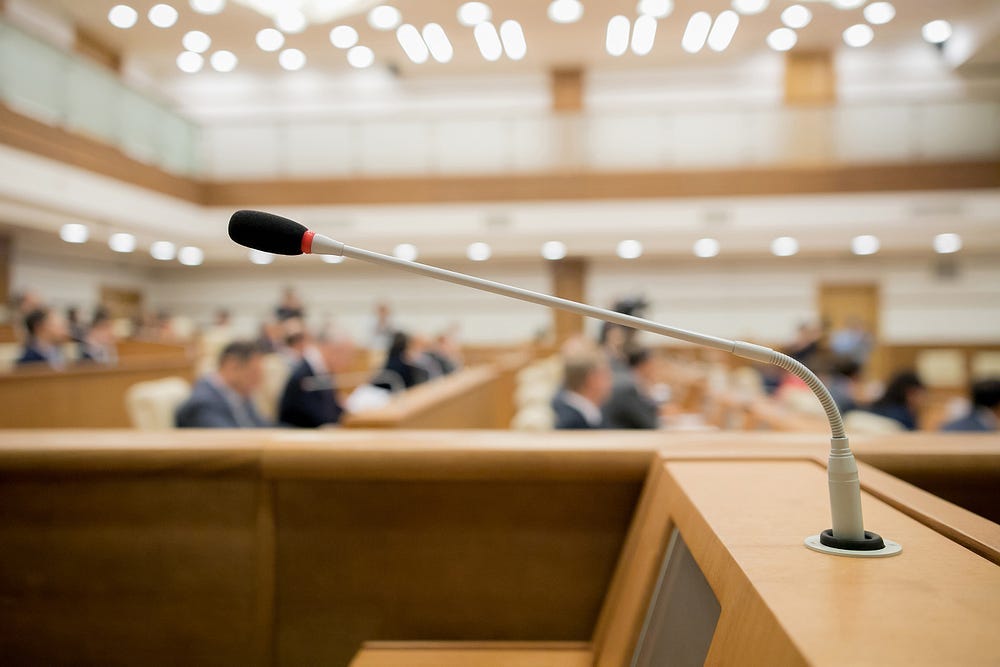Photo of Congress in session with an empty mic at the podium