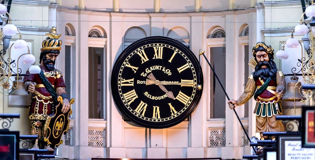 black and white analog clock at 10 00