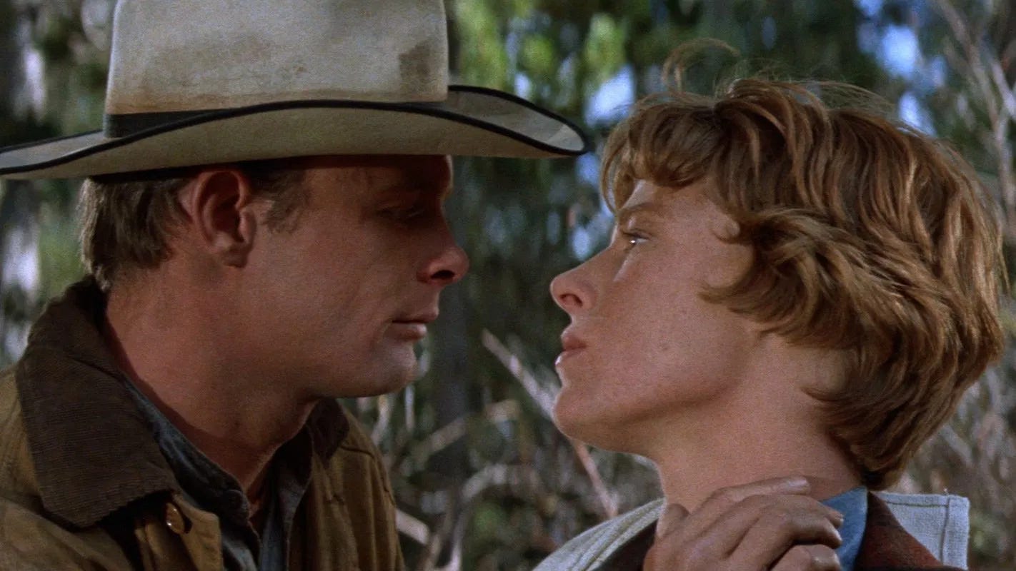 Ron Starr holds his hand up to Mariette Hartley's neck as the two stare into each other's eyes; the gesture might be tender or threatening. A screenshot from Ride the High Country (1962).