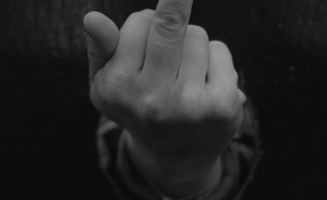 a person pointing a finger at the camera