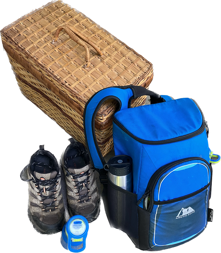Life jackets, paddler wearing life jacket, backpack, water bottles, picnic basket, and outdoor shoes