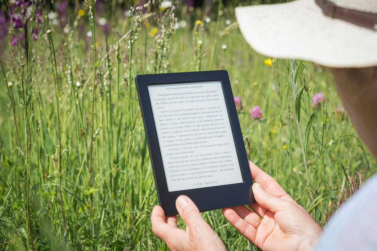woman reading an ebook on tablet (sell ebooks at Payhip)