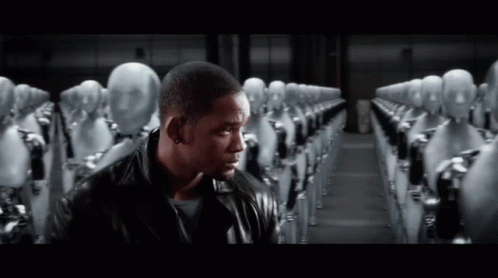 a man in a leather jacket stands in front of a row of robots a man in a leather jacket stands in front of a row of robots