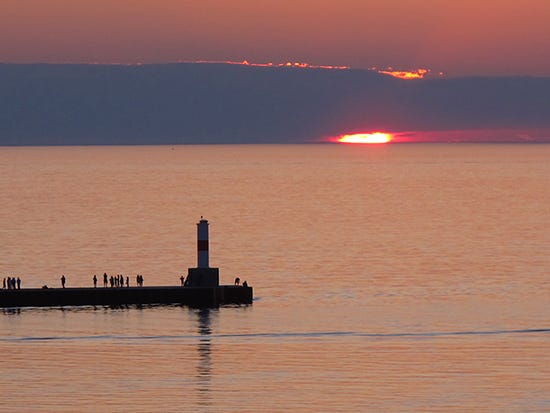 Petoskey Sunset, Lake Michigan, photo J. Hulsey photo of sunset over Lake Michigan with light house from Petoskey, michigan, by John Hulsey