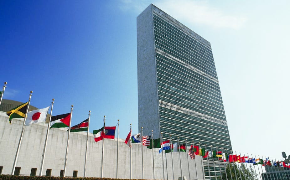 Image of a skycraper with flags of several countries.
