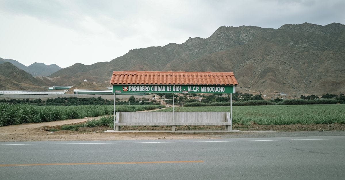 Photo: Joshuan Barboza / Pexels Scenic rural bus stop in Simbal, La Libertad, Peru, set against a backdrop of mountains and fields.