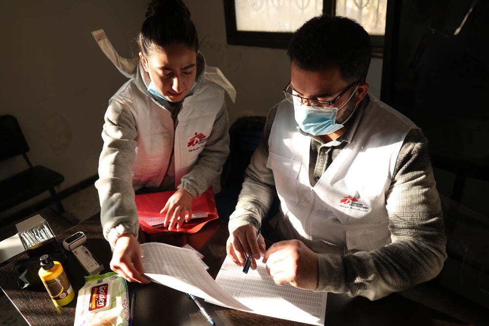 MSF medical team preparing medical data entry sheet so they can follow up with patients at MSF mobile clinic in east Ghouta, Syria.