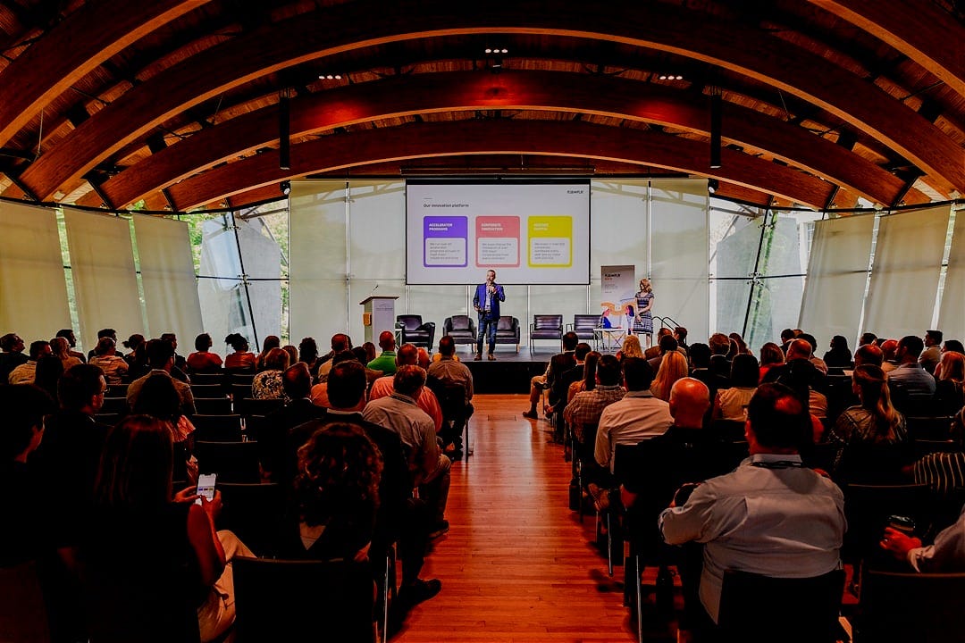 a man giving a presentation to a group of people a man giving a presentation to a group of people