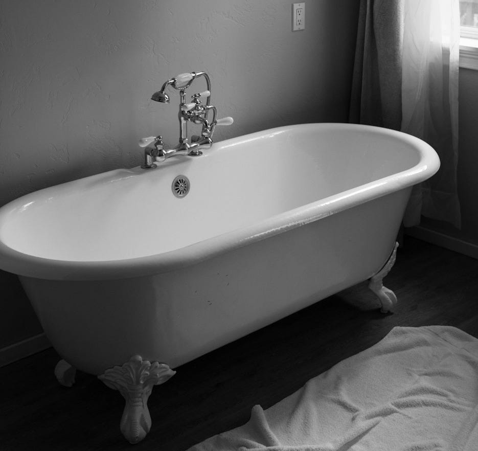 white ceramic bath tub inside room