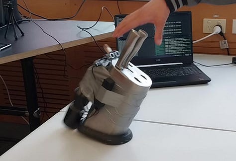 A toaster and microwave with microphones, and a knife block with googly eyes and a 'mouth' open for screaming