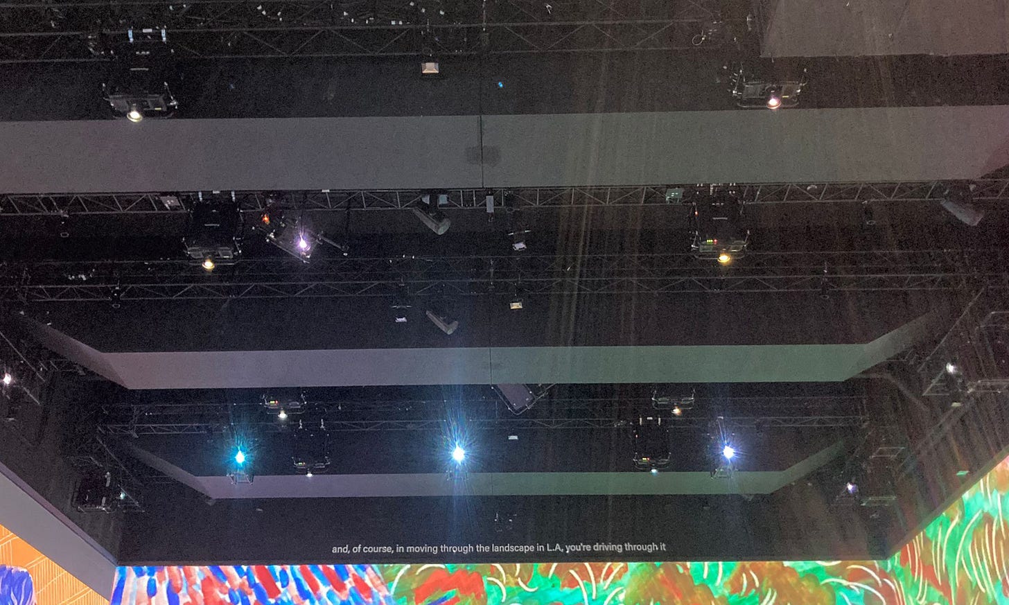The projectors of the immersive experience visible on the ceiling