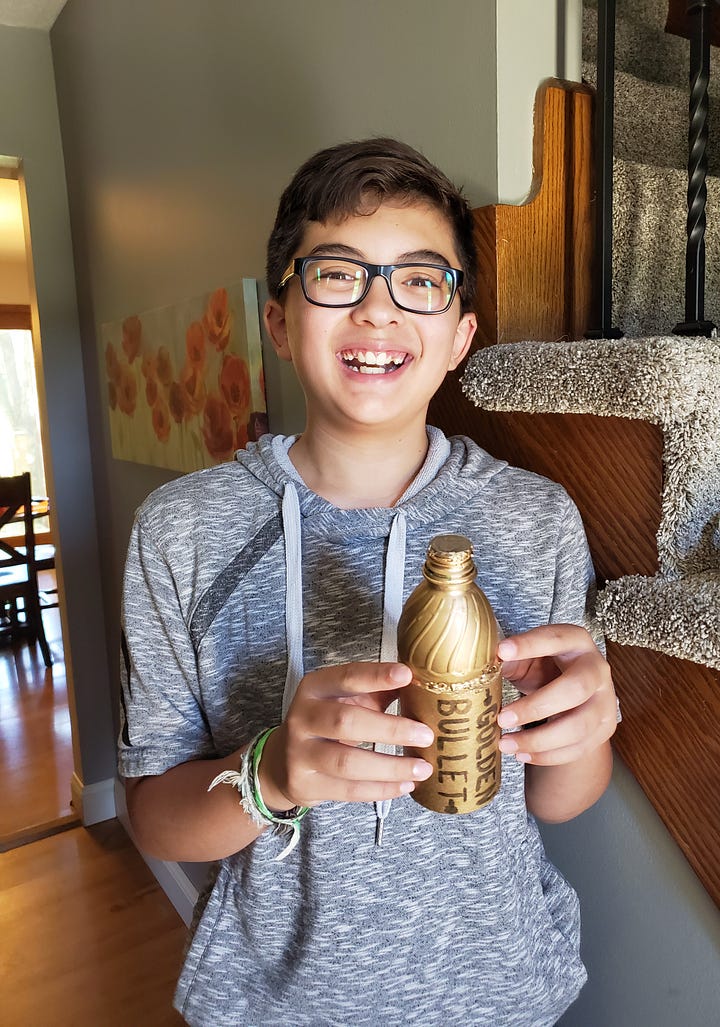 Posing with his cabin counselor and his riflery award