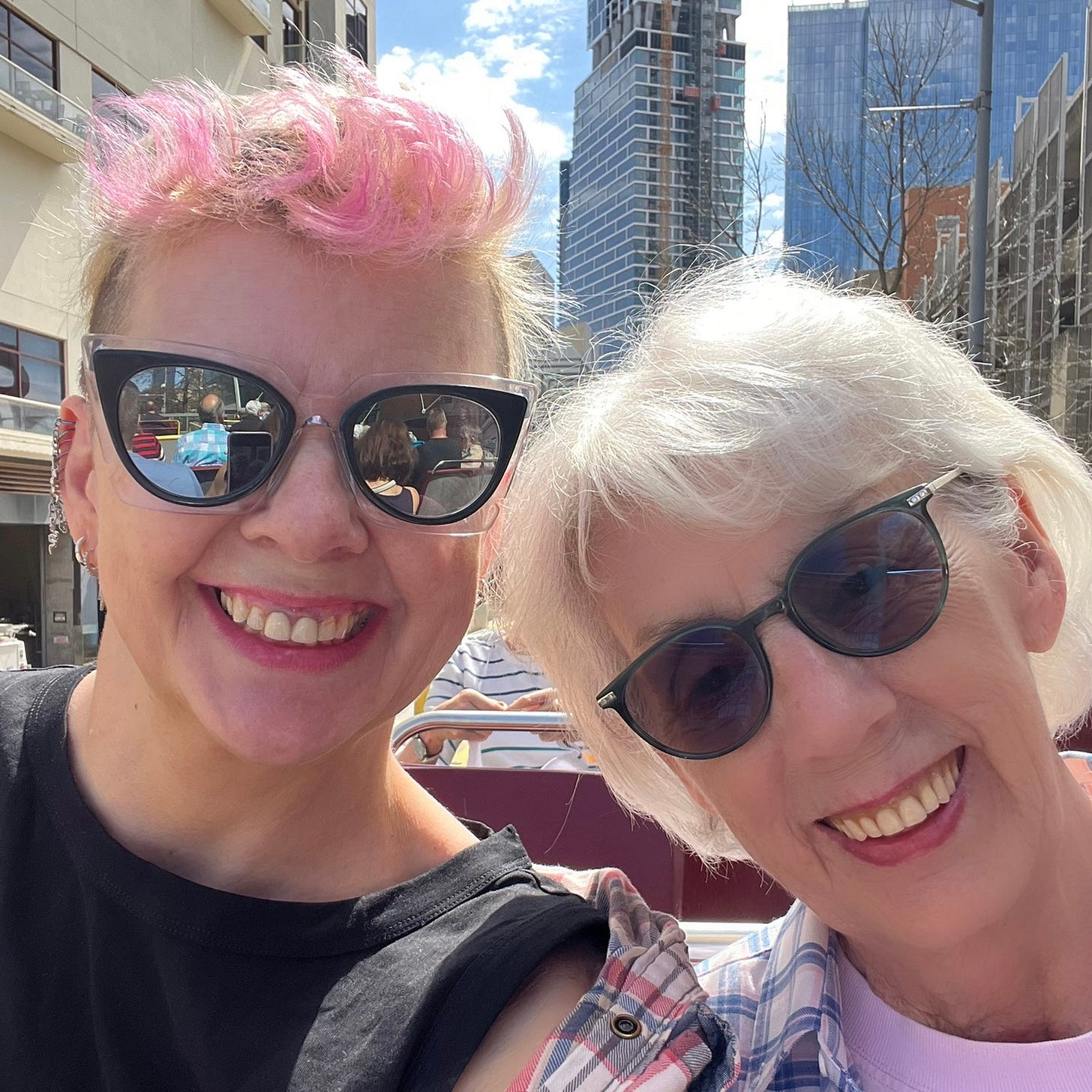 A selfie of my mom and me on a double-decker tour bus in Austin