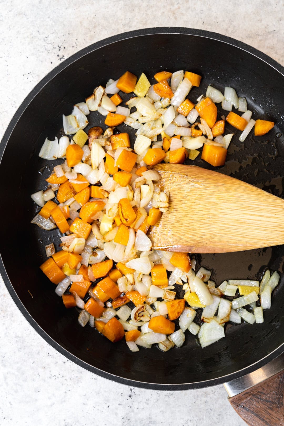 stir frying onion, carrot, garlic, and ginger.