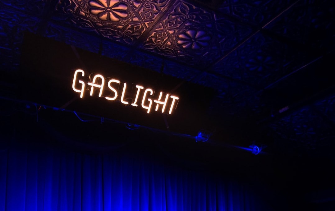a stage with a blue curtain and a sign that reads gaslight