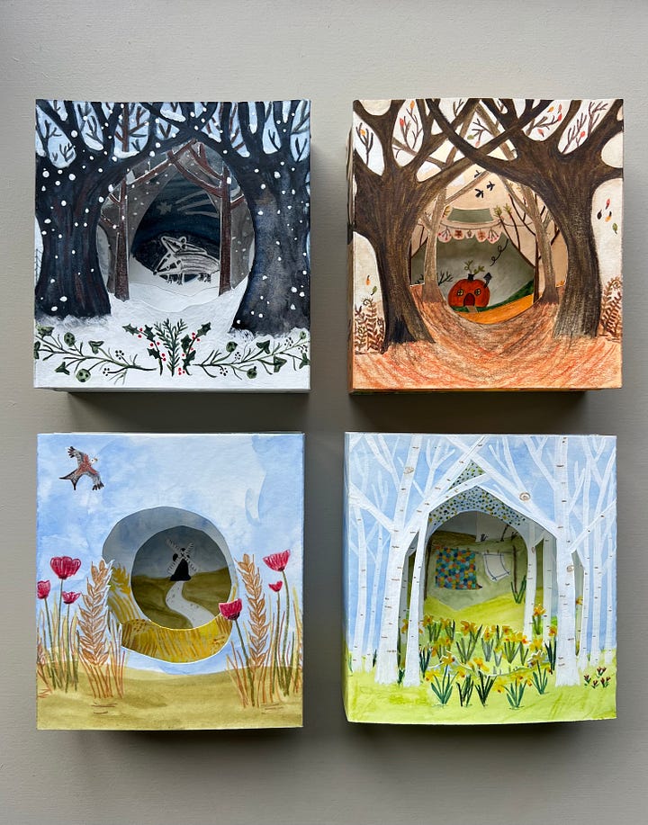 A collection of paper tunnel books handmade depicting the four season illustrated in watercolour and ink