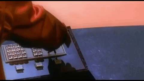 In the transporter room, Chris pushes up a lever while Lance looks at the computer screen and mouths "Wow!"