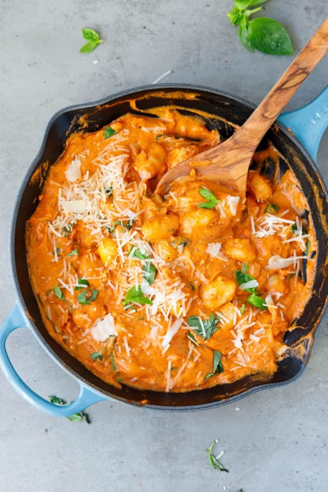 A cast iron skillet with creamy tomato sauce gnocchi A cast iron skillet with creamy tomato sauce gnocchi