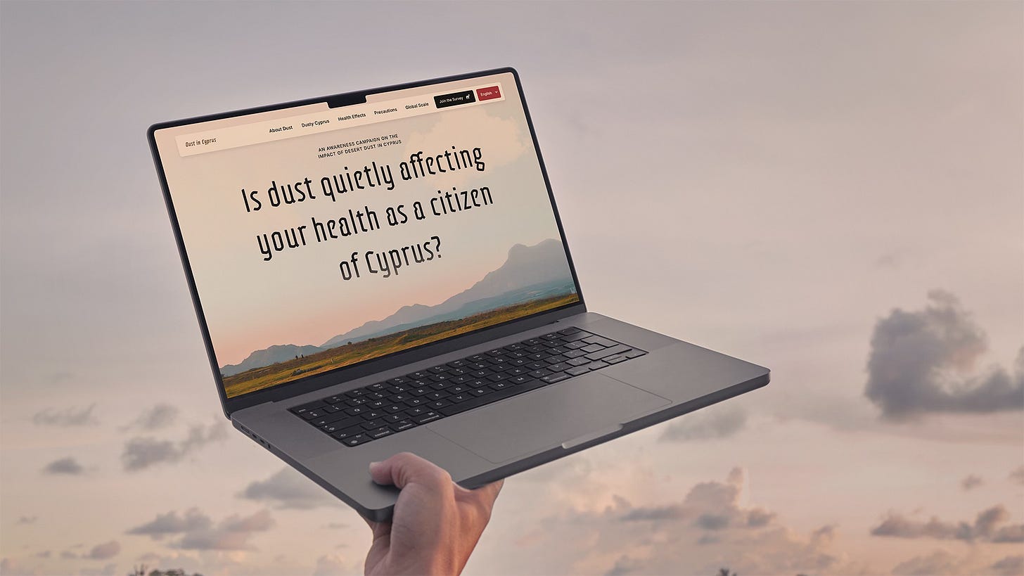 A hand holds up a laptop against a pastel sky. The screen shows Dust in Cyprus website with the headline: “Is dust quietly affecting your health as a citizen of Cyprus?”