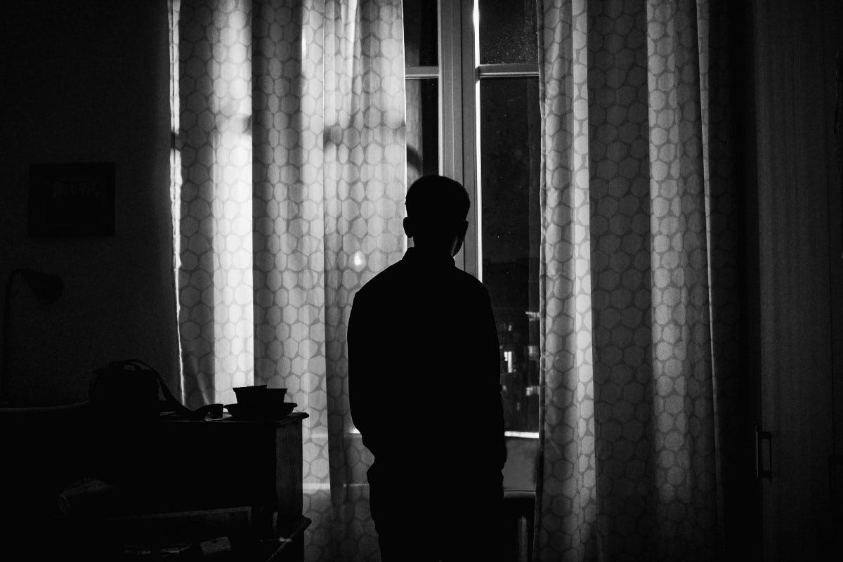 silhouette of person standing inside room silhouette of person standing inside room