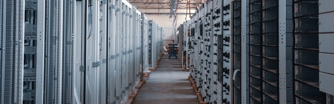 brown wooden hallway with gray metal doors