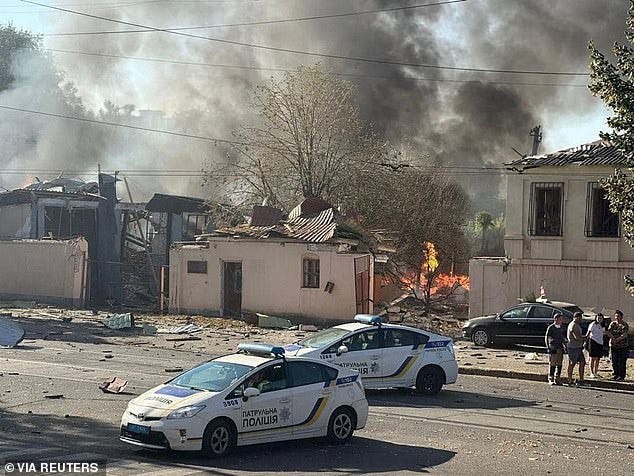 Police cars are seen at a site of a Russian missile strike amid Russia's attack on Ukraine