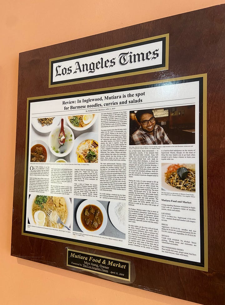 Photos of the LA Times articles posted onto cherry wood plaques. 