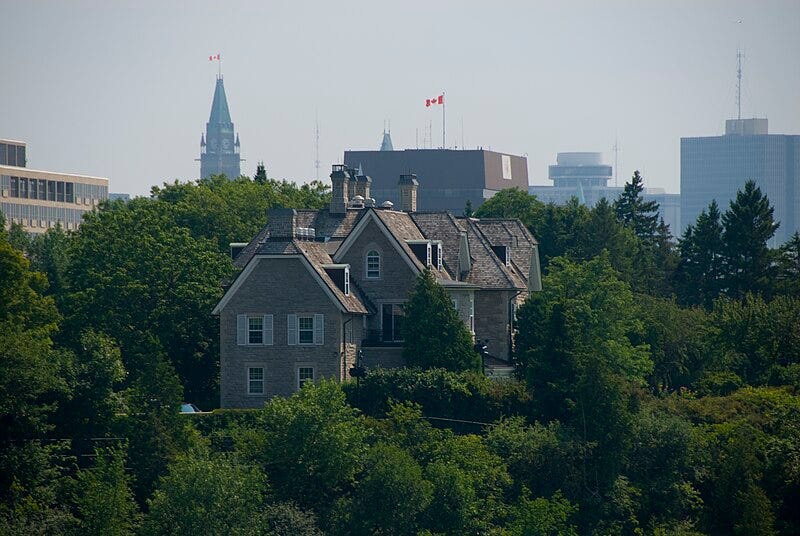 24 Sussex, the official residence of Canada's prime minister, pictured against a backdrop of trees, with the Parliament buildings in the background. 24 Sussex, the official residence of Canada's prime minister, pictured against a backdrop of trees, with the Parliament buildings in the background.
