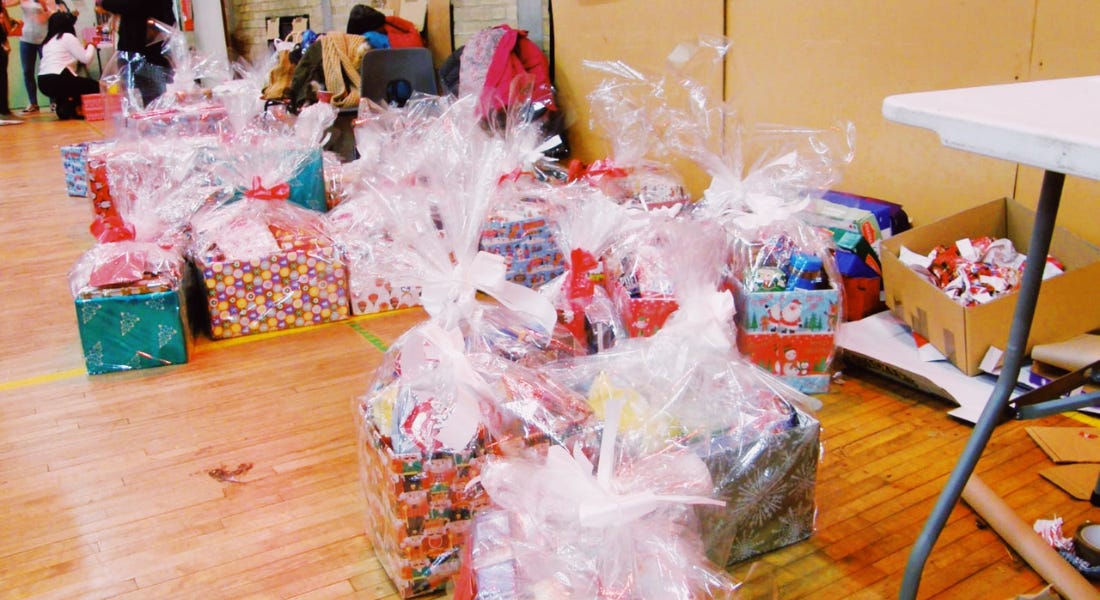A wooden floor with wrapped boxes with colourful wrapping paper on them A wooden floor with wrapped boxes with colourful wrapping paper on them