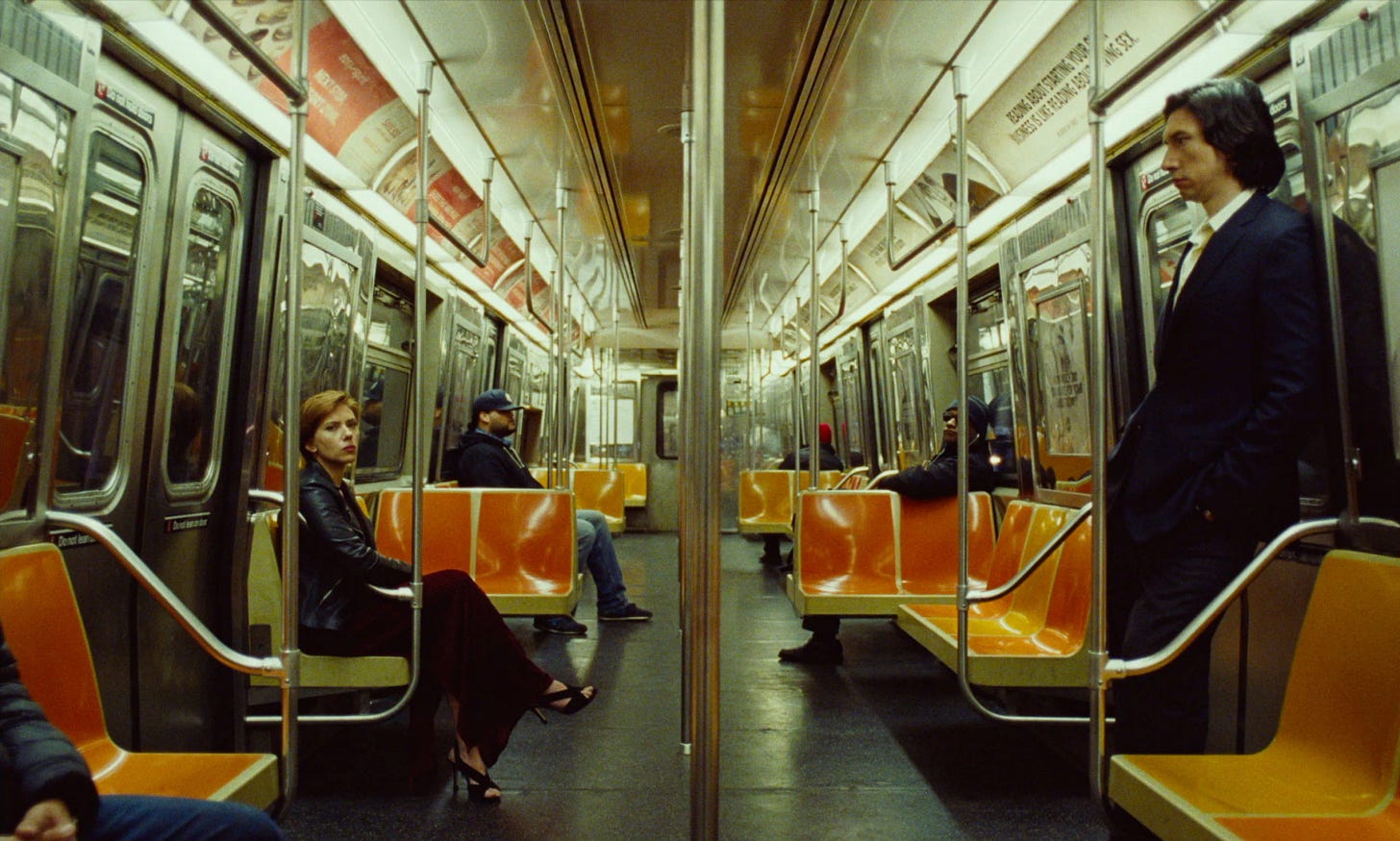 Scarlett Johansson and Adam Driver in 2019 film A Marriage Story. They are on opposite sides of a subway car, icily ignoring each other.