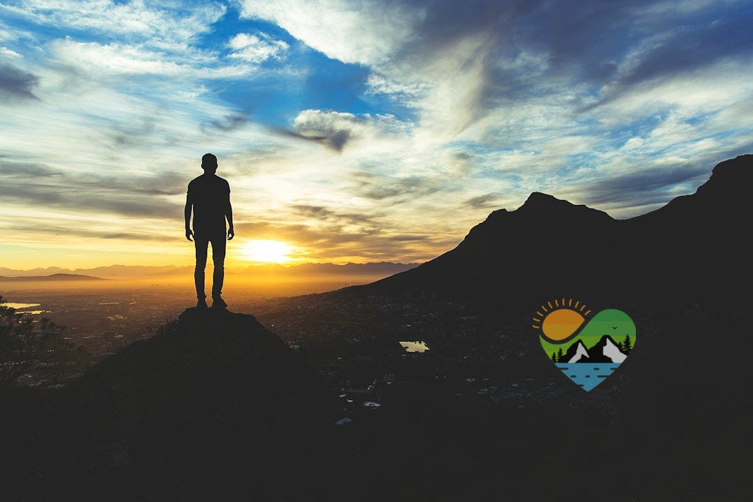 person standing at the top of mountain