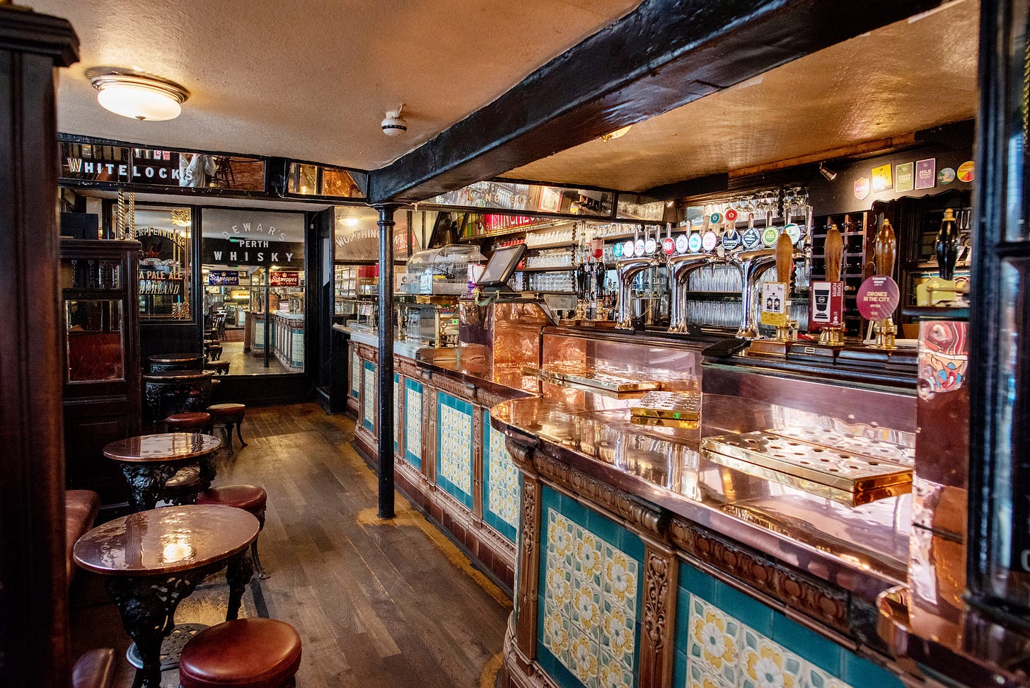 narrow bar at whitelocks, lovely tiles on the bar, plenty of copper, wooden floors narrow bar at whitelocks, lovely tiles on the bar, plenty of copper, wooden floors