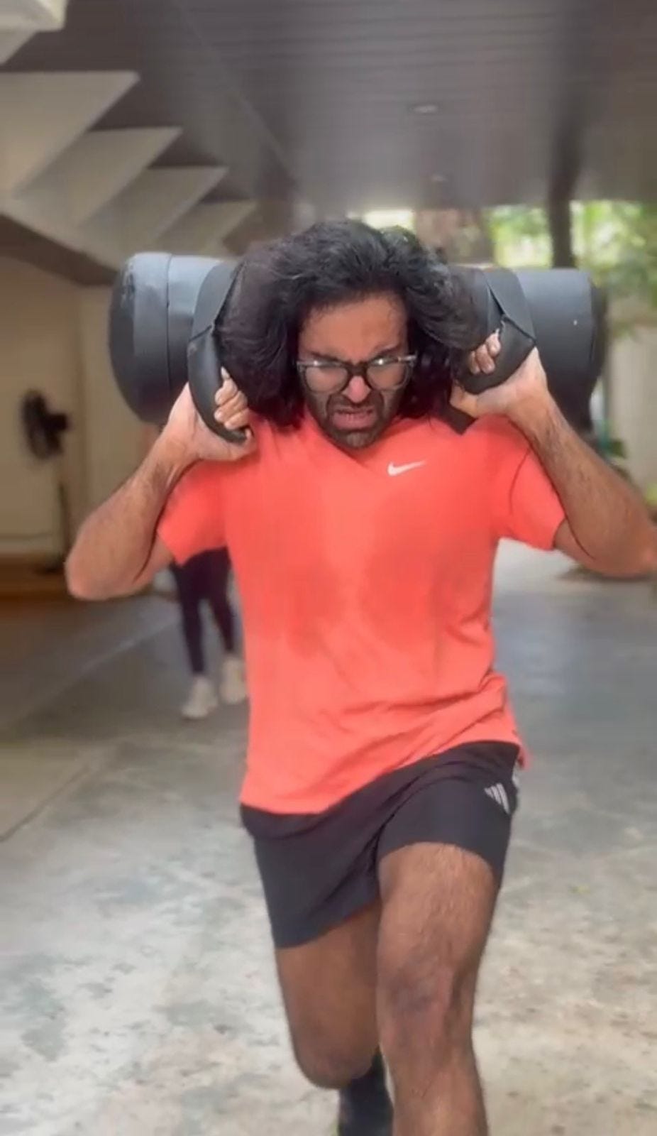 Me doing sandbag lunges at a HYROX simulation