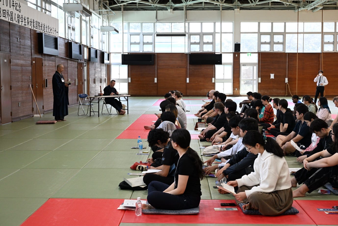 A group of people sitting on the floor

AI-generated content may be incorrect.