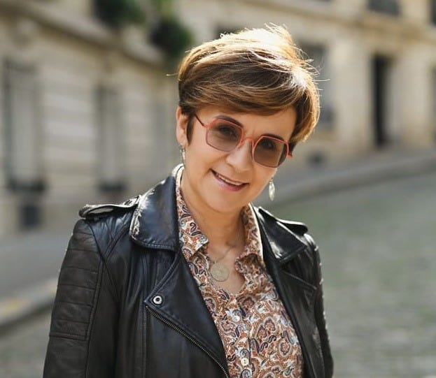 Véro, France tour guide and French language instructor smiling an a French street Véro, France tour guide and French language instructor smiling an a French street