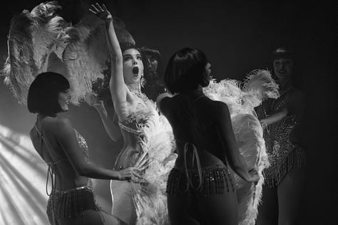 images of burlesque performers on stage with artistic lighting