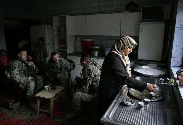 An Iraqi woman continues her daily chores while US soldiers from Baker Company, 2-12 Infantry Battalion, temporarily occupy her home during a patrol in southern Baghdad, March 16, 2007. An Iraqi woman continues her daily chores while US soldiers from Baker Company, 2-12 Infantry Battalion, temporarily occupy her home during a patrol in southern Baghdad, March 16, 2007.