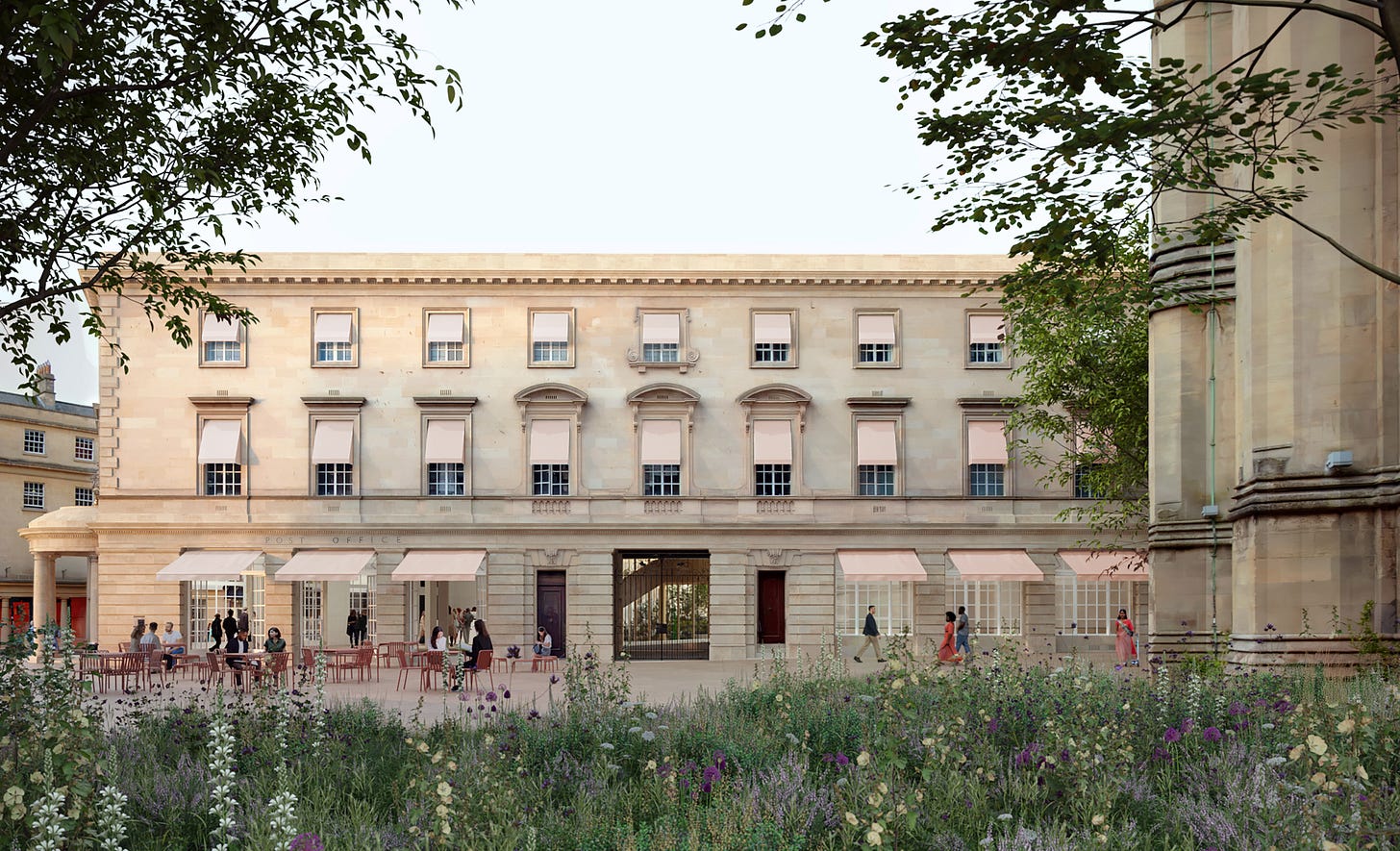 A grand, classical facade of the building, the new Fashion Museum Bath, with red cafe tables outside and greenery and wildflowers in the foreground